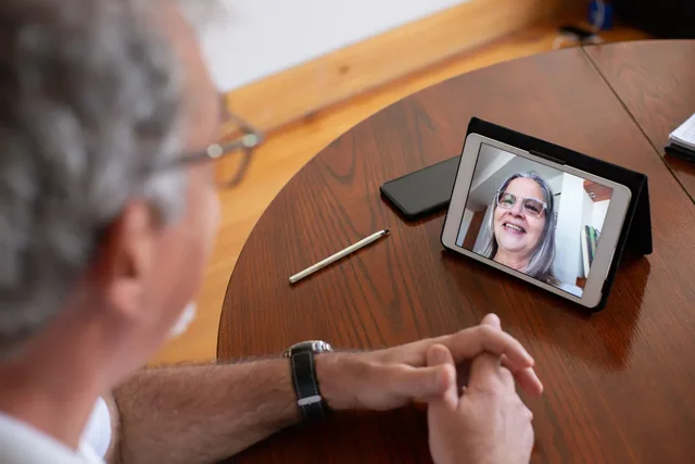 A person taking part in a video conversation on a tablet