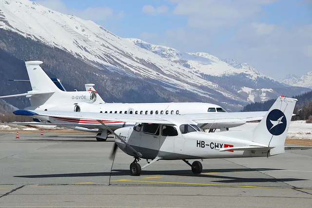 Translation services Crest translation services: aircraft parked at an airport with mountains in the distance