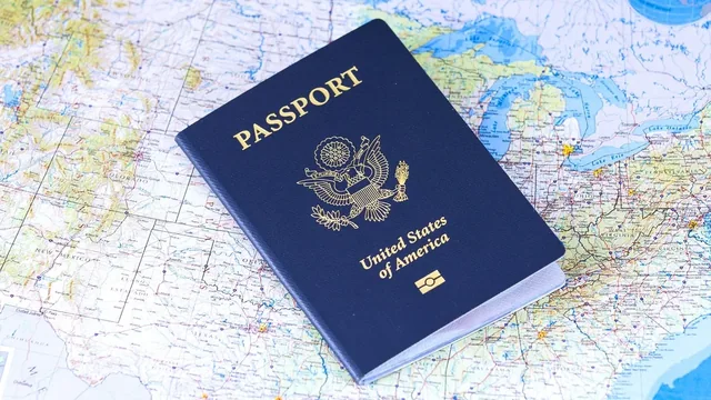 A closed United States passport resting on a map