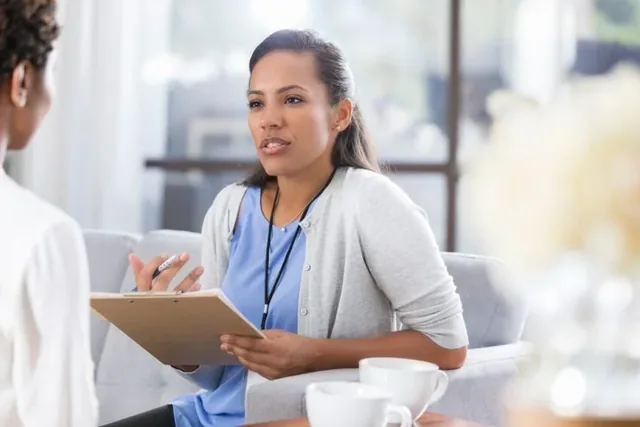 Crest translation services: a healthcare professional discussing notes during a consultation