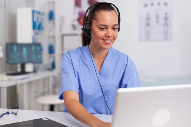 Interpreting services Crest interpreting services: a healthcare professional using a headset and laptop