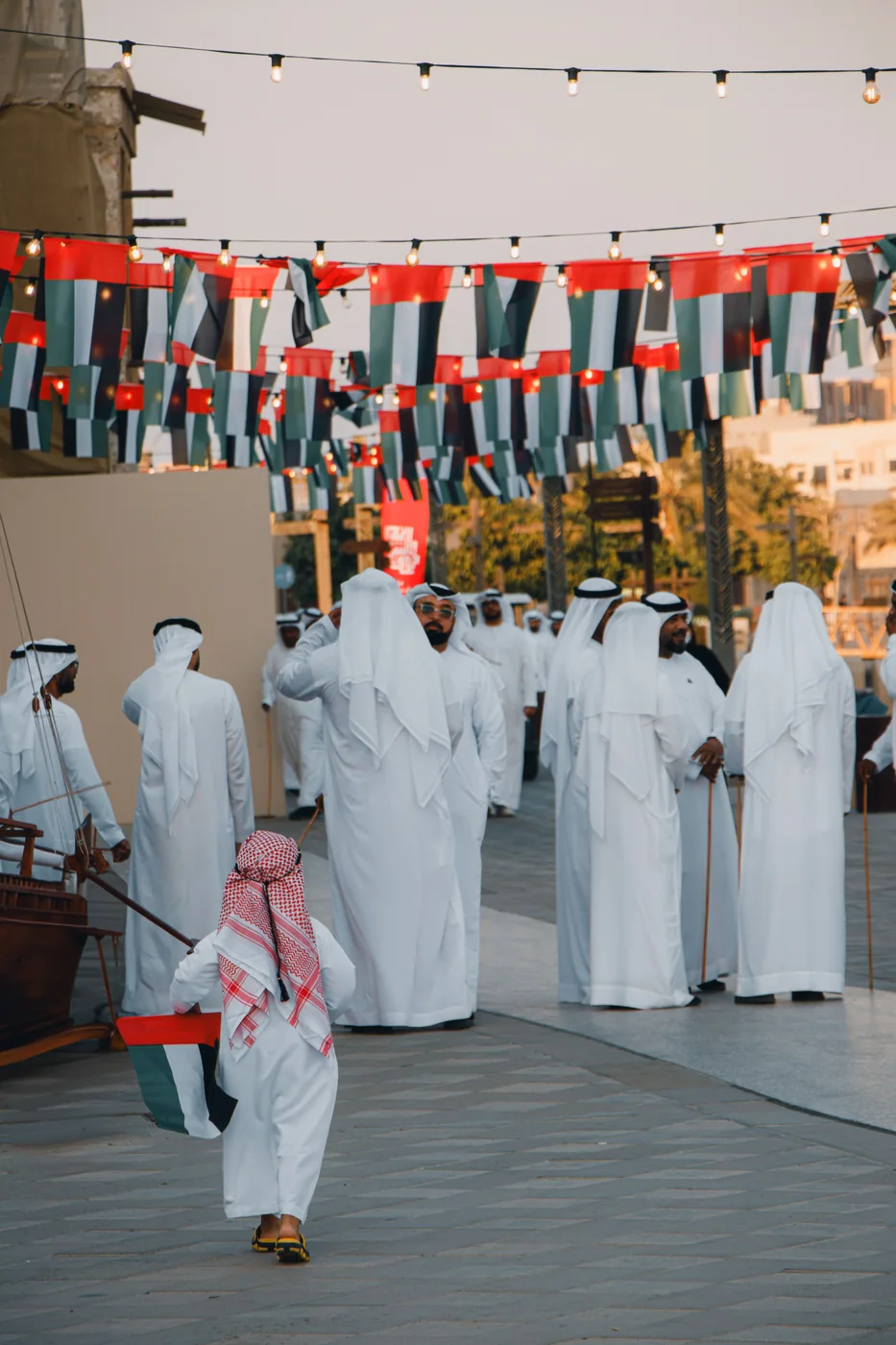 People on a street decorated with flags
