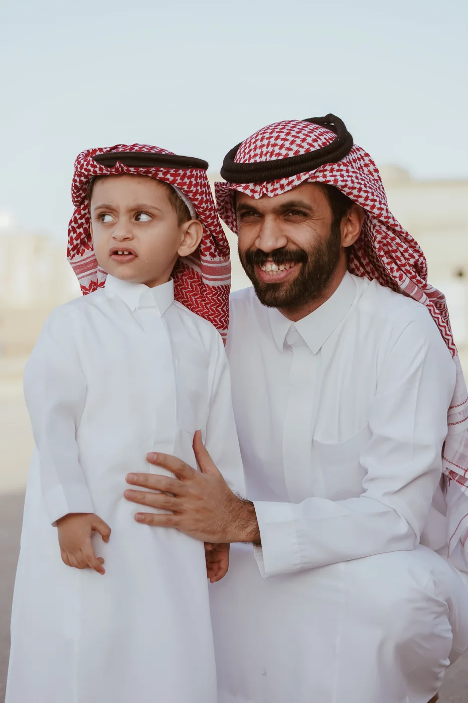 An adult and child smiling together