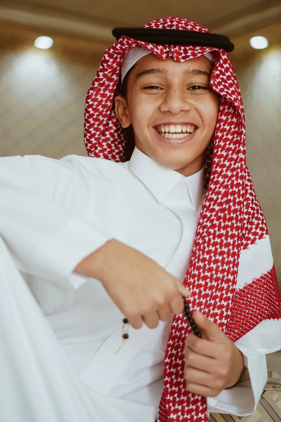 A young person smiling in traditional clothing