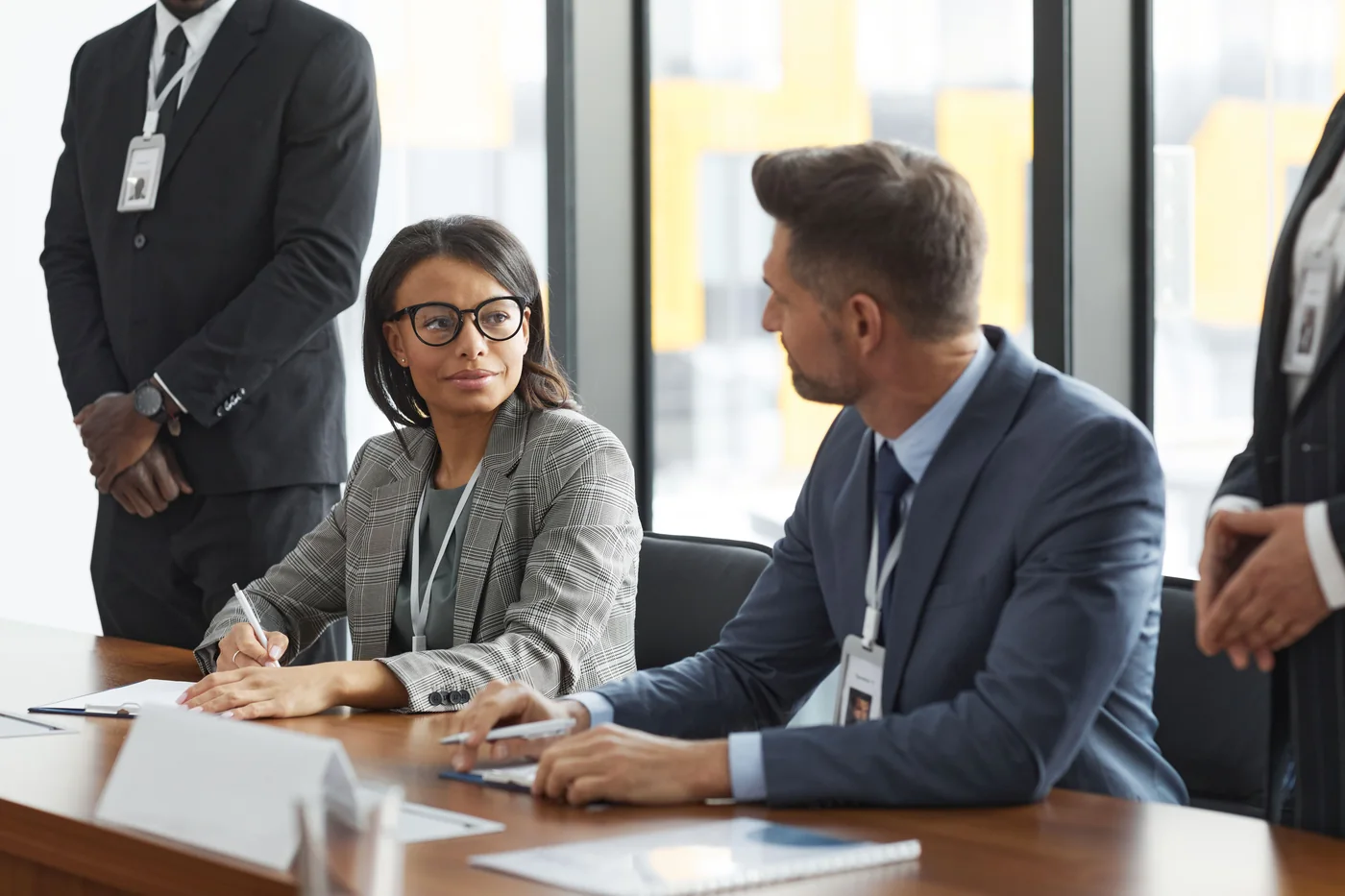 Professionals discussing information across a desk