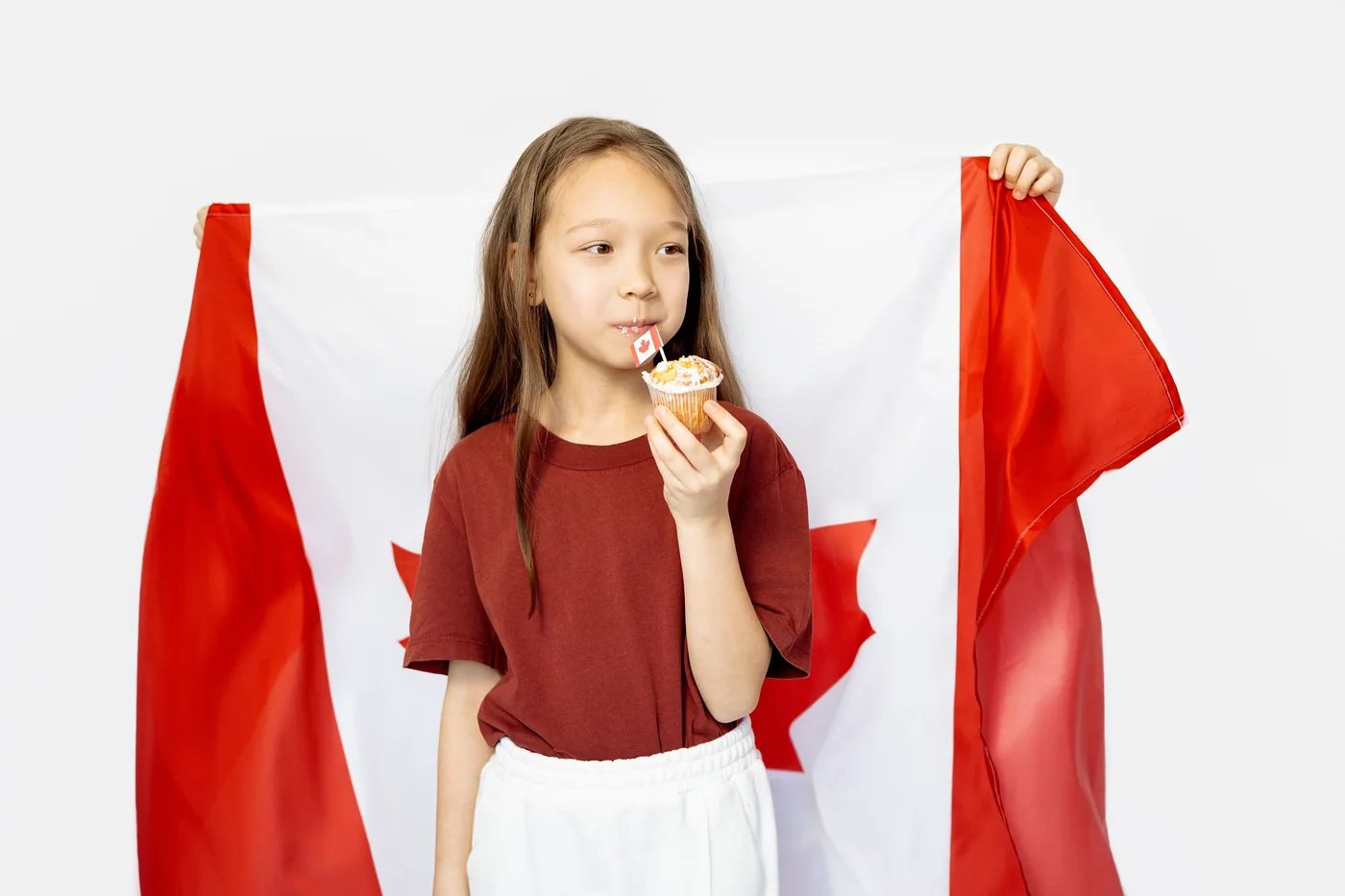 A child holding a Canadian flag