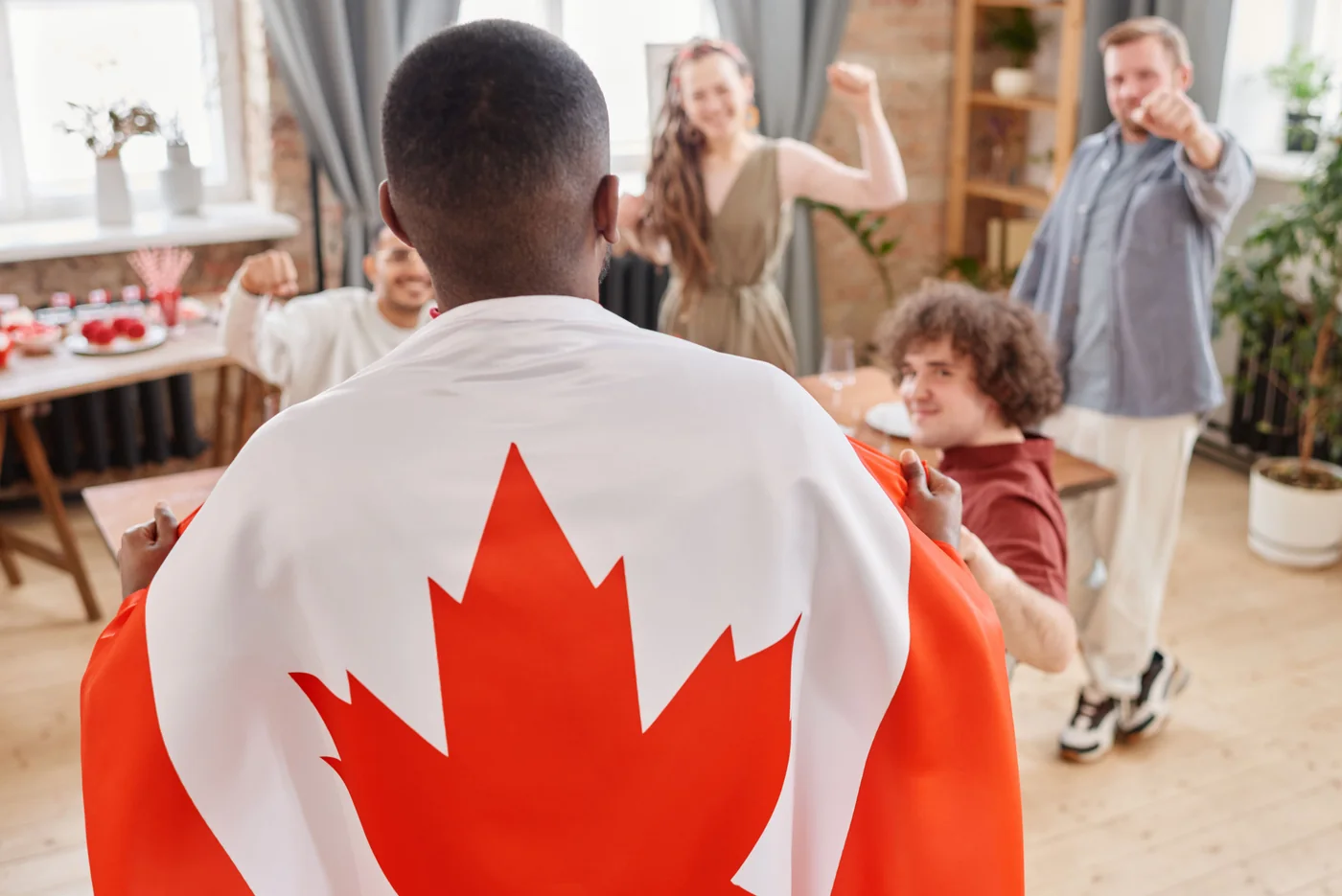 People celebrating together with a Canadian flag
