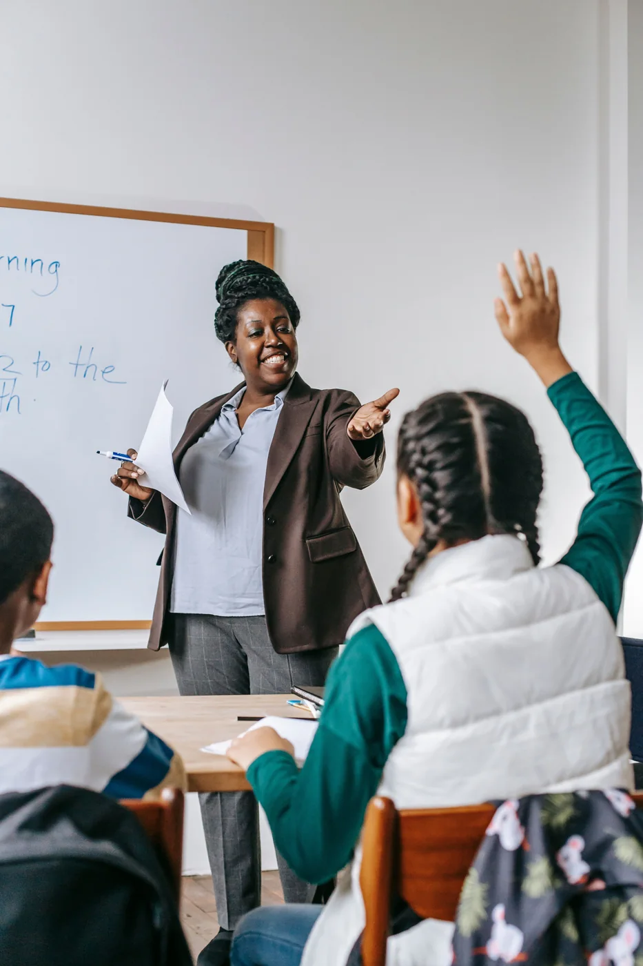 A teacher leading a discussion with students in a classroom