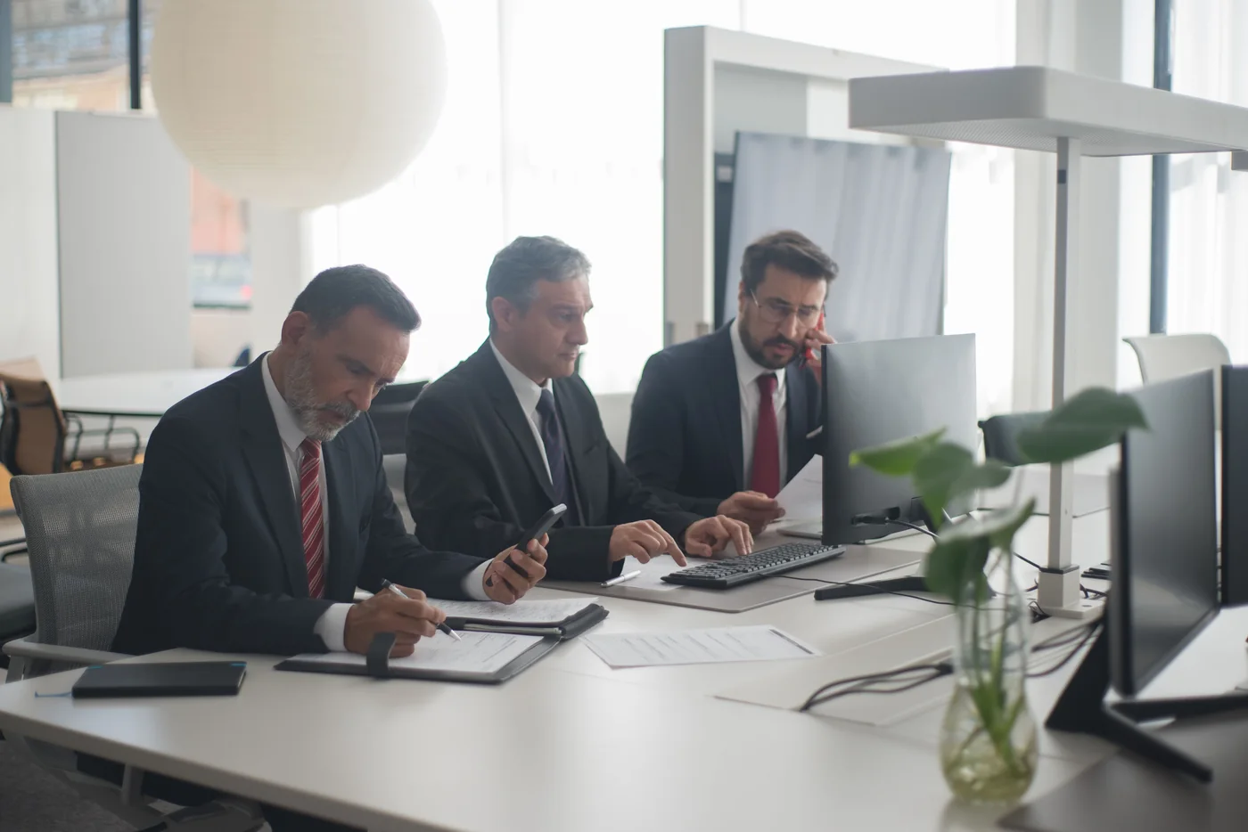 Professionals reviewing documents around a meeting table
