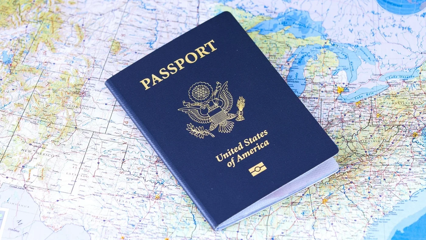 A closed United States passport resting on a map