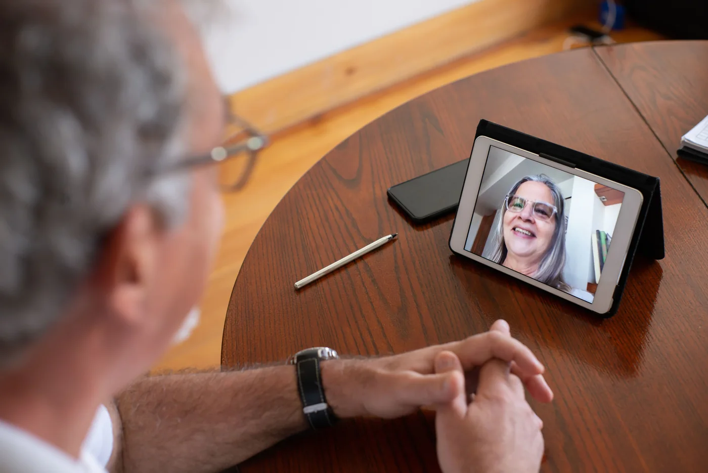 A person taking part in a video conversation on a tablet